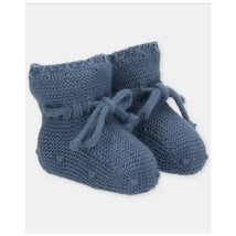 Light blue knitted baby booties with bows, featuring textured stitching and a soft, warm design.
