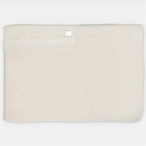 Sweater knit blanket in a soft sage color, featuring a decorative button and textured edge detail.