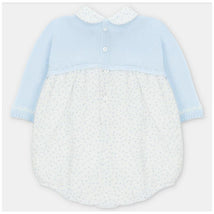 Pastel blue short romper with a knitted top and a woven polka dot bottom, featuring a collar and button closure.