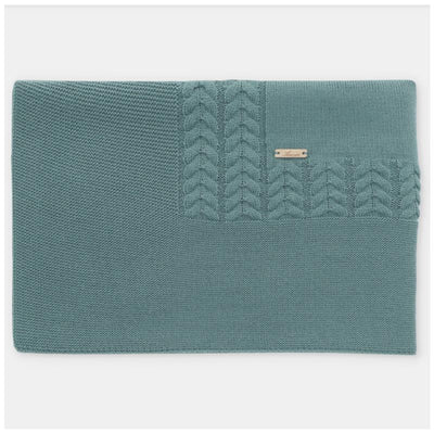Blue-grey Draylon sweaterknit blanket by Martin Aranda, featuring a textured cable knit design and a small logo tag.