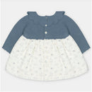 Sweater-knit dress with a blue bodice and white skirt featuring animal patterns and buttons at the front.