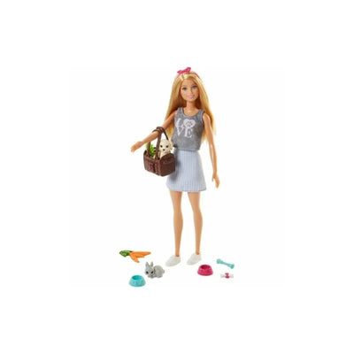 Barbie doll with blonde hair, wearing a gray tank top and striped skirt, holding a basket with two pets and accessories nearby.