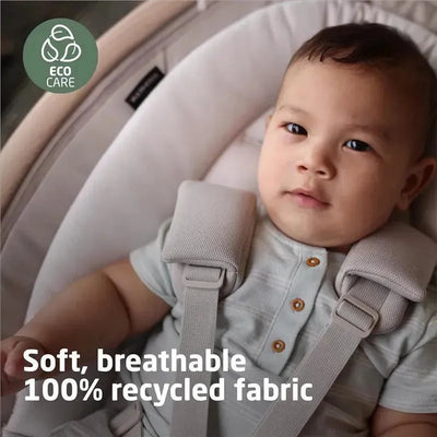 Maxi-Cosi Cassia Swing in Classic Green with a baby, featuring soft, breathable recycled fabric and an eco-care badge.