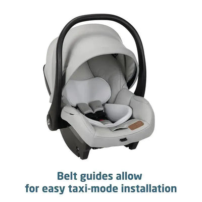 Maxi-Cosi Gia XP Luxe infant car seat in light gray with a black handle, featuring belt guides for easy taxi-mode installation.