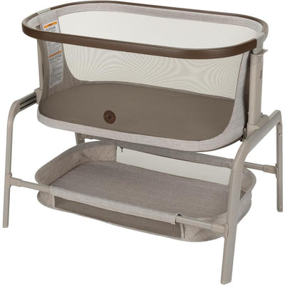 Maxi-Cosi Iora Baby Bassinet in Truffle color, featuring a mesh side for airflow and a lower storage shelf.