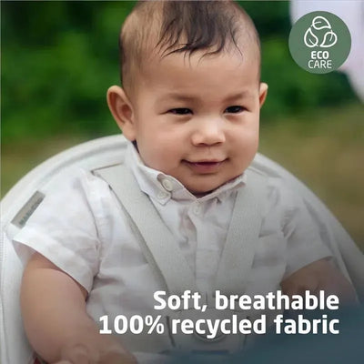Maxi-Cosi Moa 8-in-1 Highchair in Classic Green with a baby smiling, featuring soft, breathable 100% recycled fabric.