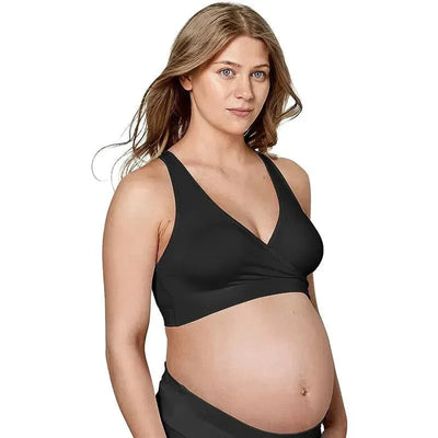 Black Medela Keep Cool Sleep Bra worn by a pregnant woman, featuring a cross-over design and adjustable straps.