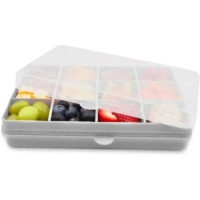 Grey divided snack container with 12 compartments, filled with various fruits like grapes, blueberries, and strawberries.