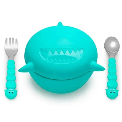 Turquoise silicone shark bowl with lid, accompanied by a fork and spoon, all featuring playful designs.