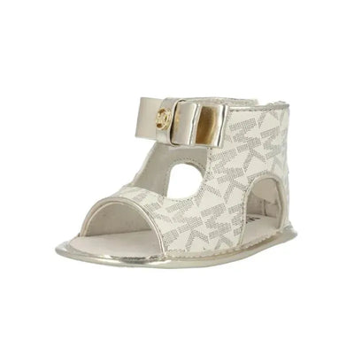 Michael Kors Babytill Dahnia 3 Vanilla Mono crib shoes, featuring an open-toe design, decorative buckle, and logo pattern.
