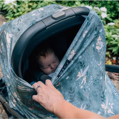 Milk Snob Disney 5-in-1 multifunctional cover featuring Tinker Bell design, partially covering a sleeping baby in a stroller.