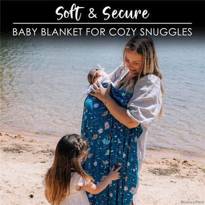 Soft and secure baby blanket featuring Finding Nemo characters, wrapped around a mother holding her baby by the water.