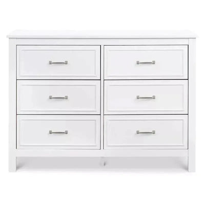 White six-drawer double dresser with simple design and silver handles, ideal for nursery or bedroom storage.
