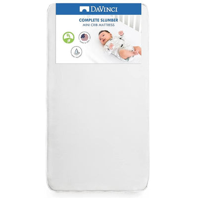 Complete Slumber mini crib mattress by DaVinci, features a white surface with a package label showcasing a baby.