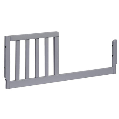 Grey toddler bed conversion kit with slats, designed for transitioning a mini crib to a toddler bed.