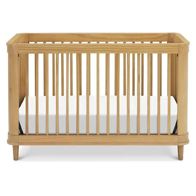 3-in-1 convertible crib in honey finish, featuring wooden slats, round corners, and a white mattress inside.