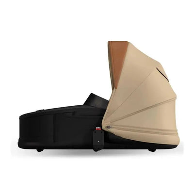 Mima Creo Bassinet in black with a light tan canopy, designed for infant comfort and safety. Canopy not included.