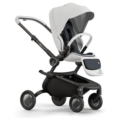 Single stroller in white with a spacious canopy, comfortable seating, and a black base with four wheels for easy maneuverability.