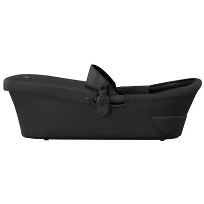 Mima Xari MAX Carrycot in black, featuring a sleek design, side handle, and secure attachment mechanism.