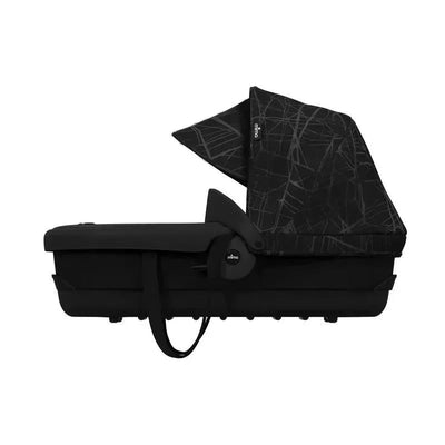 Mima Zigi carrycot in ebony color with a patterned canopy, designed for infants, featuring safety straps and an adaptor.