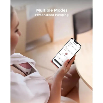 Hands-free Momcozy M9 double breast pump operated via smartphone app displaying multiple personalized pumping modes.
