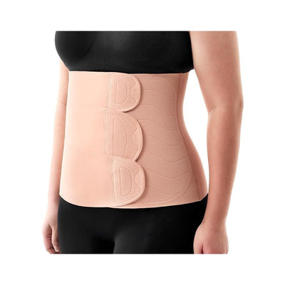 Momcozy Ergowrap™ postpartum belly wrap in light pink, worn by a woman, featuring adjustable closures and a smooth design.