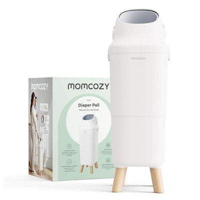 White Momcozy Triple-Seal Diaper Pail with wooden legs beside its packaging, featuring product details and benefits.