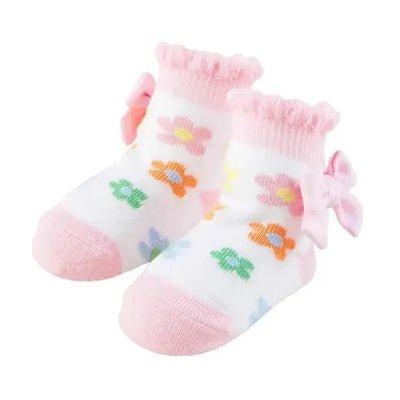 Baby girl socks with colorful flower patterns and a bow, suitable for ages 0 to 12 months.