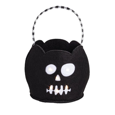 Black felt Halloween treat bucket shaped like a skull, featuring LED lights for illumination and a checkered handle.
