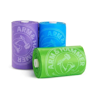 Arm & Hammer diaper bag refill rolls in purple, blue, and green, featuring branding and designed for disposal purposes.