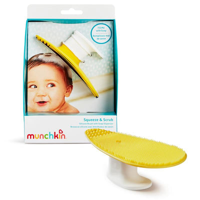 Silicone baby bath brush with a soap dispenser, featuring a yellow textured surface and a smiling baby in the background.