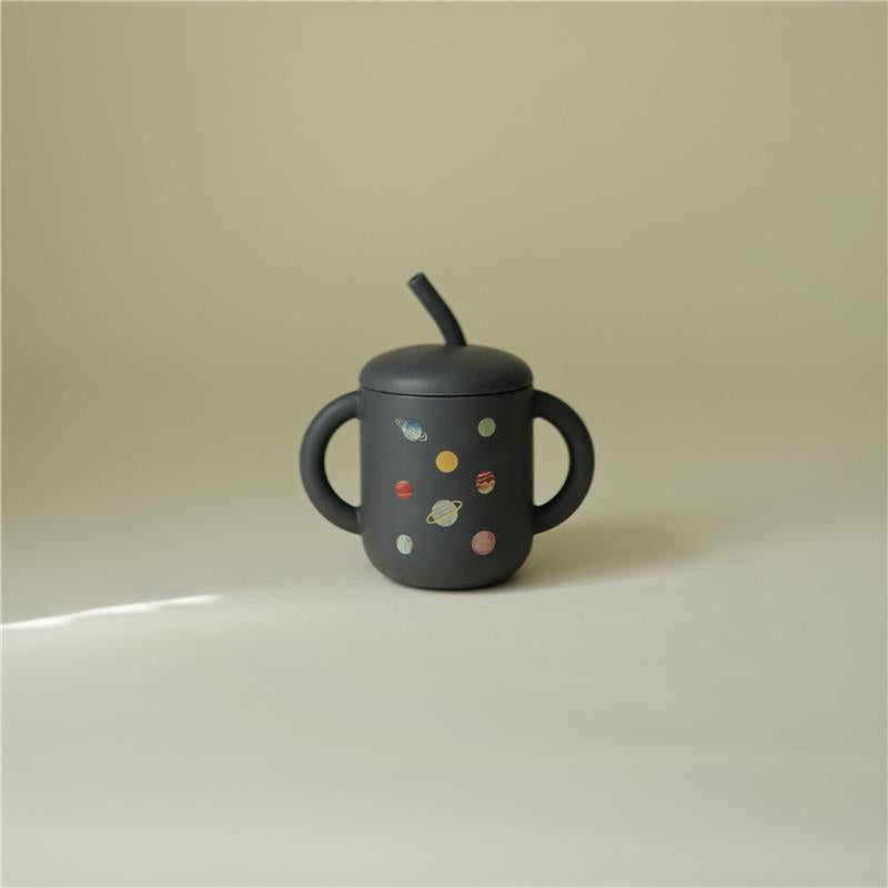 100% silicone training cup for toddlers, featuring a black body with colorful planet designs and a straw.