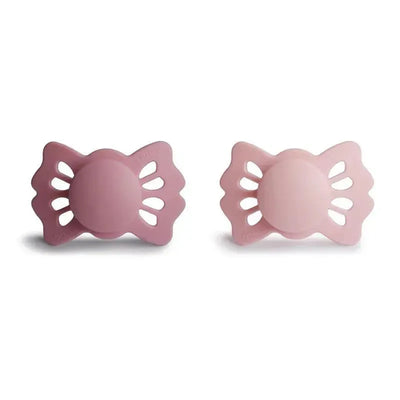 Symmetrical silicone pacifiers in cedar and baby pink, designed for infants aged 0 to 6 months.