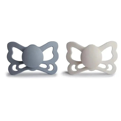 Two butterfly-shaped silicone pacifiers in grey and white, designed for infants aged 6 to 18 months.