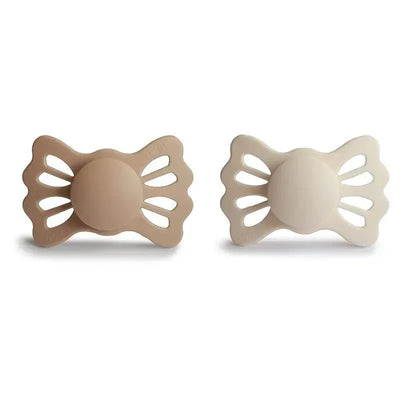 Silicone pacifiers in silky satin and cream colors, designed for ages 6 to 18 months, with symmetrical shapes.