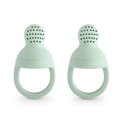 Two Mushie silicone fresh food feeders in Cambridge Blue, designed for infants to safely explore solid foods.