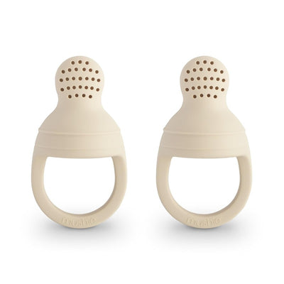Mushie Silicone Fresh Food Feeder 2-Pack in a sandy beige color, designed for safe feeding with perforated tops for food access.