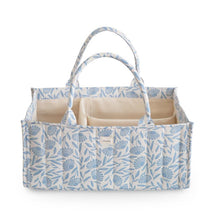 Mushie Baby Diaper Caddy in blue floral design, featuring multiple compartments for organizing newborn essentials.