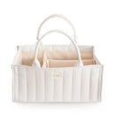 Mushie Baby Diaper Caddy in ivory, featuring two handles and divided compartments for organizing newborn essentials.