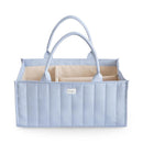 Light blue Mushie Baby Diaper Caddy with quilted design and multiple compartments for organizing newborn essentials.
