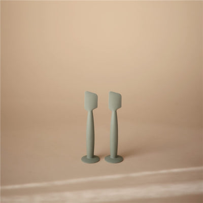 Mushie Silicone Diaper Cream Applicator in Cambridge Blue, featuring two ergonomic applicators with flat tips for easy use.