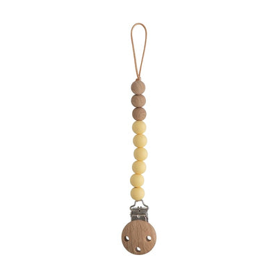 Mushie Eva pacifier clip in muted yellow, featuring wooden and silicone beads with a metal clip at the end.