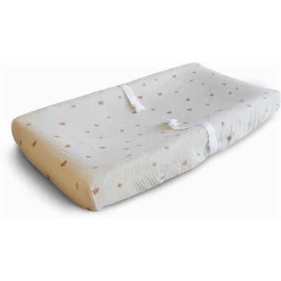 Extra soft muslin changing pad cover in white with small brown patterns and ribbon ties for secure fitting.