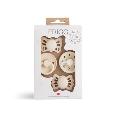 Mushie FRIGG baby pacifier set for 0-6 months featuring four cream-colored designs in a box.