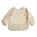 Water-resistant, long-sleeve baby bib with a beige background and colorful dinosaur prints, featuring an adjustable fit.
