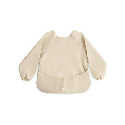 Long sleeve bib in a light fog color, featuring elastic cuffs and a pocket at the bottom for catching spills.