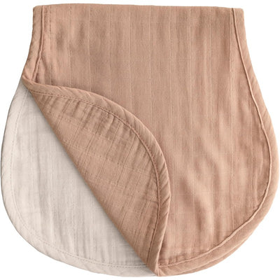 Mushie organic cotton muslin burp cloths in natural and fog colors, featuring a soft, textured fabric with rounded edges.