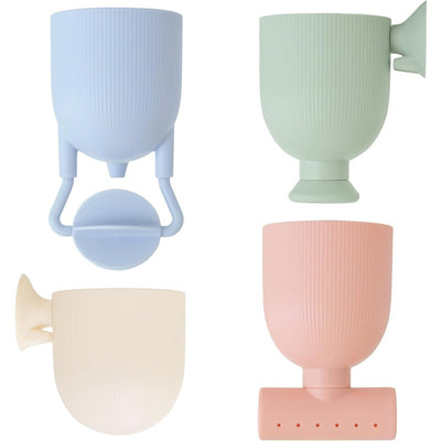 Four pastel silicone bath toys in blue, green, pink, and cream, designed for pouring and playing during bath time.