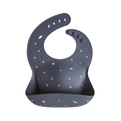 Mushie Silicone Baby Bib in navy with colorful planet designs and a pocket for catching spills.