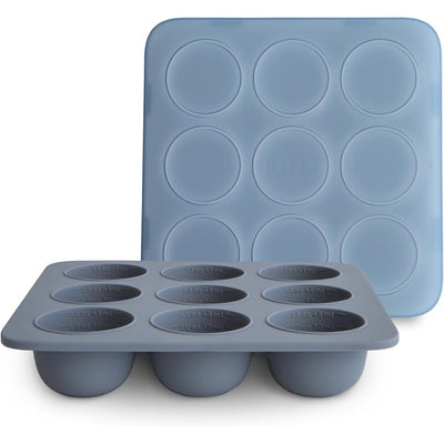 Silicone baby food freezer tray with nine round compartments, labeled with measurements for serving sizes, in light blue.